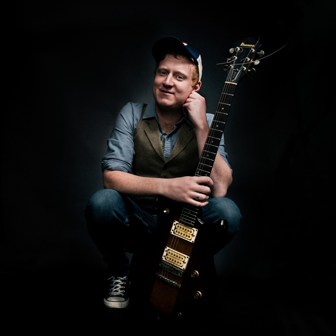 NZ musician Lachie Hayes posing with his guitar